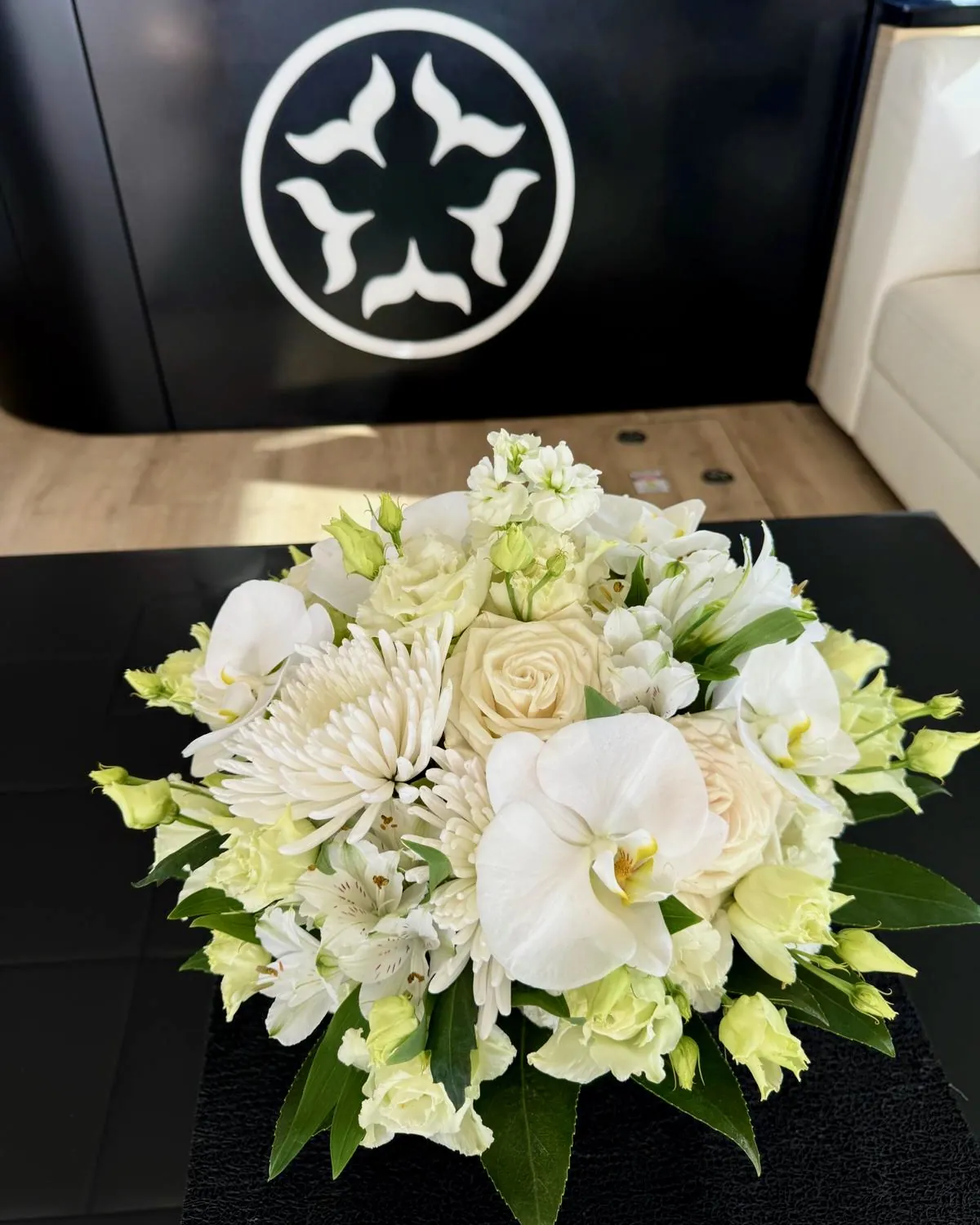 White flowers in front of the One Planet logo